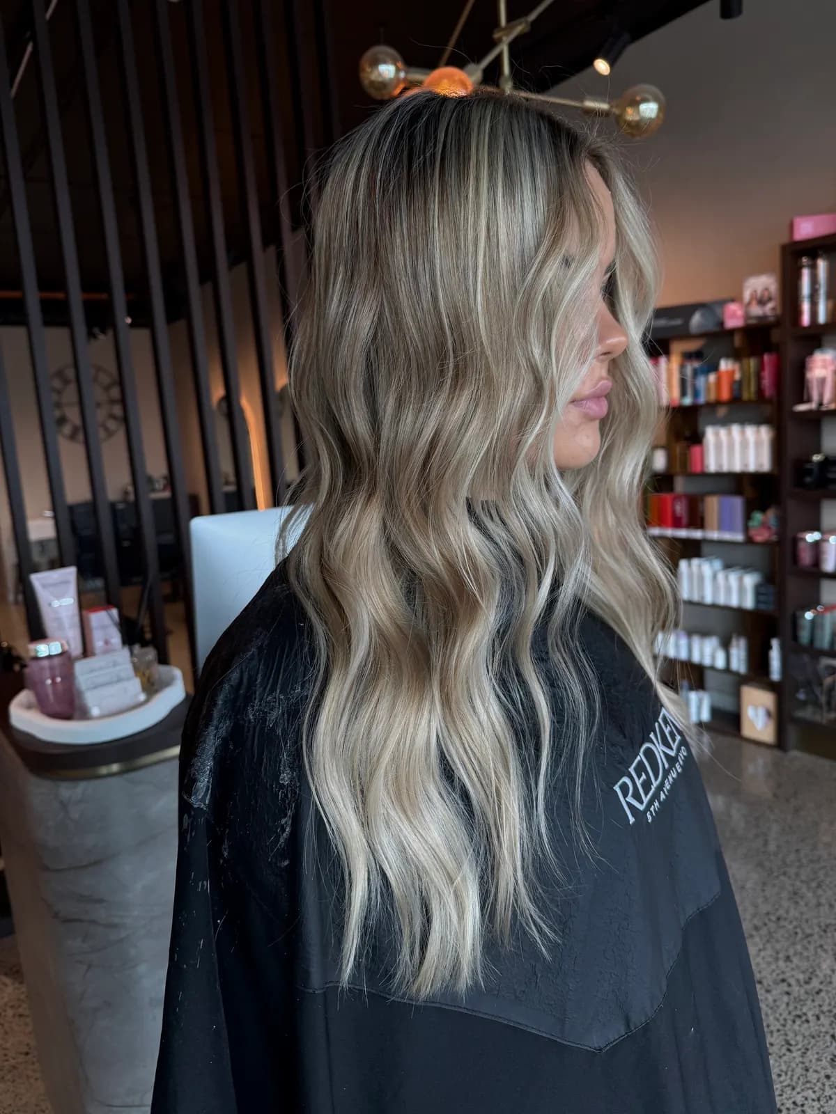 Hand-painted balayage with soft waves and a blended root