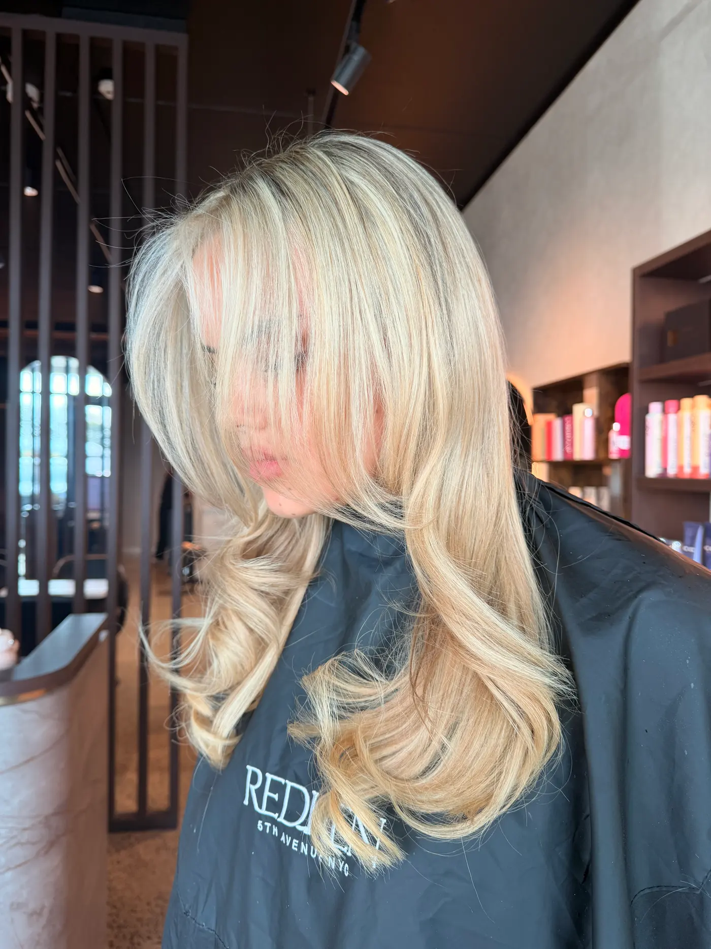 Bright blonde with curtain bangs and a bouncy blow-dry, styled in the chair at Jenna Ellen Hair, Silverdale