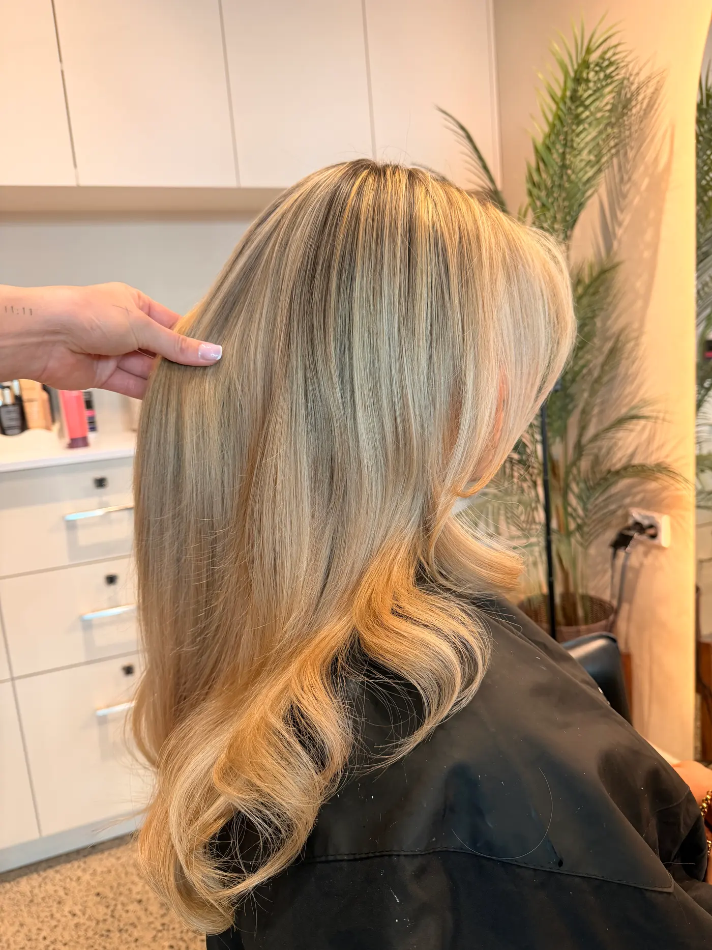 Bright golden blonde lengths with a smooth, bouncy blow-dry, held up in the chair