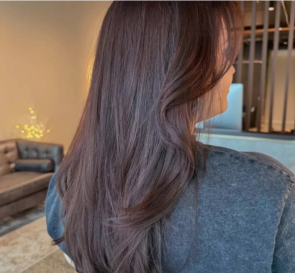 Glossy warm brunette all-over colour with soft waves