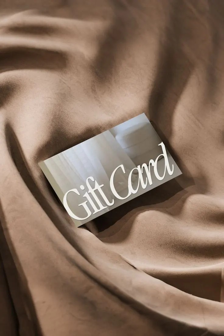 A Jenna Ellen Hair gift card on a soft beige cloth