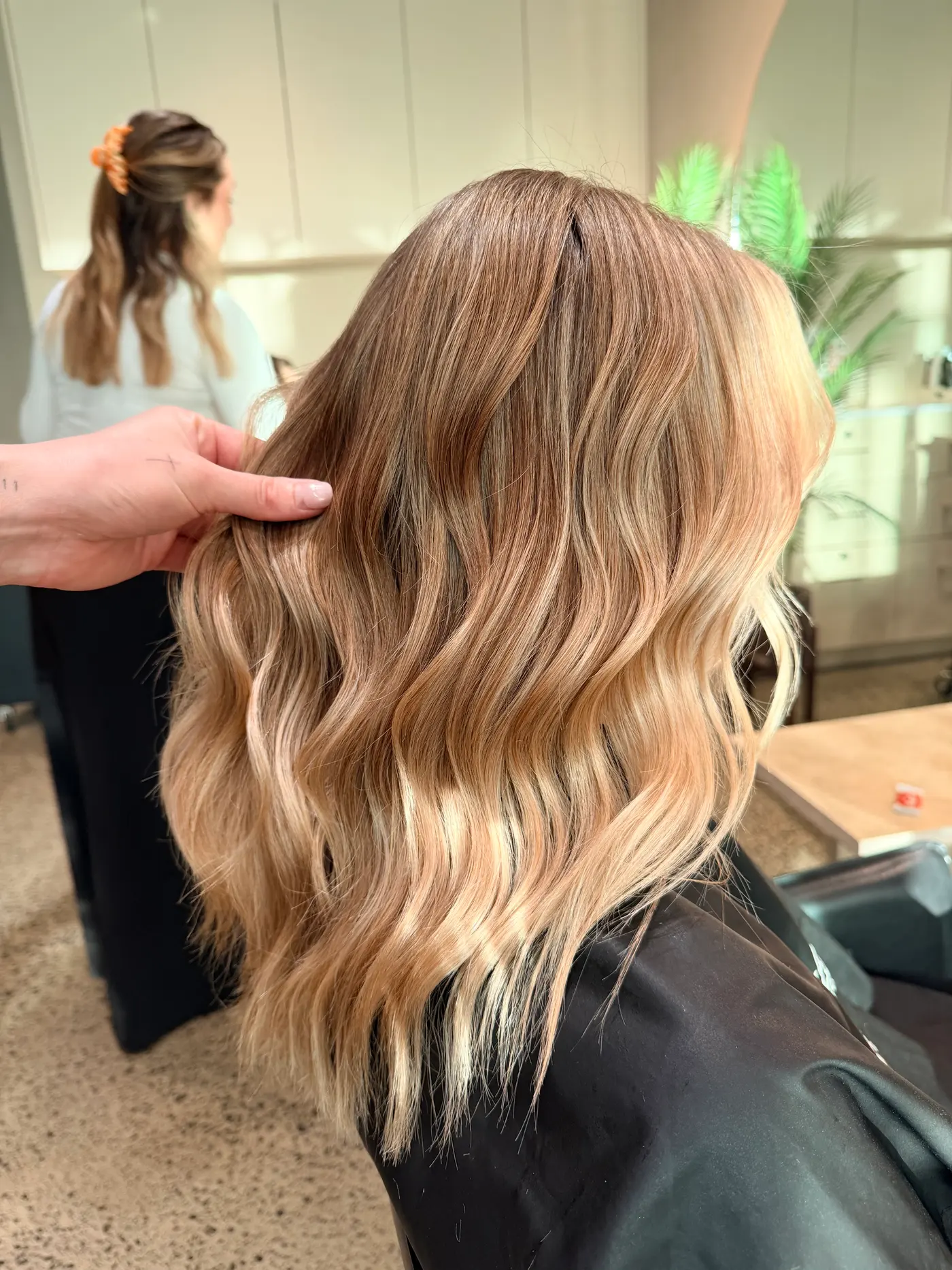 Honey and copper balayage waves, the wearable first stage of a dark-to-blonde plan, at Jenna Ellen Hair