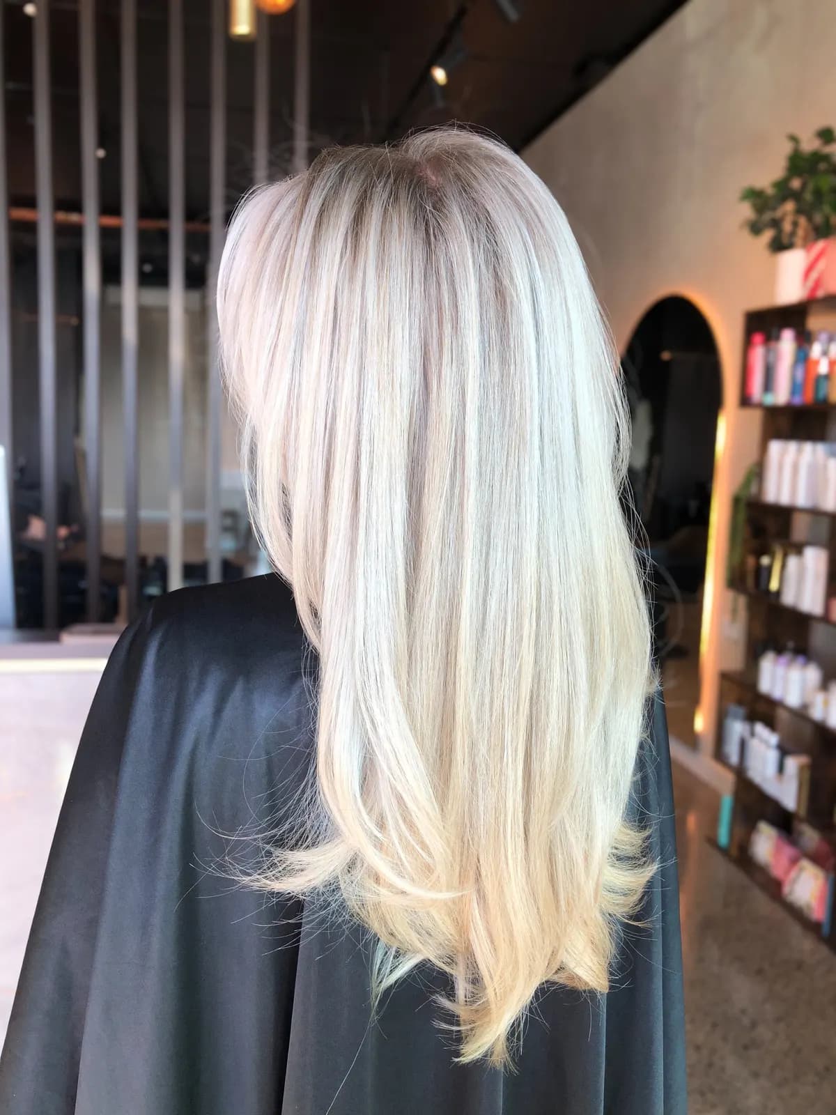 Bright platinum blonde with a natural root shadow